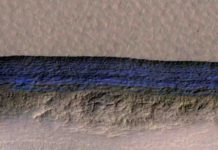 A cross-section of underground ice is exposed at the steep slope that appears bright blue in this enhanced-color view from the HiRISE camera on NASA's Mars Reconnaissance Orbiter.