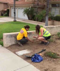 LSU's Patricia Persaud (left) and a Cal Tech undergraduate student mark a newly-buried geophone node in a Los Angeles yard.