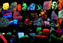 Collection of various fluorescent minerals under ultraviolet UV-A, UV-B and UV-C light. Chemicals in the rocks absorb the ultraviolet light and emit visible light of various colors, a process called fluorescence. Credit: Hannes Grobe/AWI