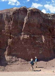 URI graduate student Reilly Hayes (left) and undergraduate Amanda Bednarick examine an outcrop for fossils at Petrified Forest National Park as part of their research. Credit: Amanda Bednarick