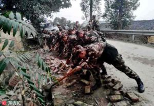Soldiers remove bricks from the road after earthquake in Rongxian county on 25 February 2019. | Credit: IC