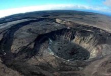 A wide-angle aerial view looks southeast over Kīlauea’s summit caldera on July 22, 2021. Large cliffs formed during the 2018 collapses are visible on the left side of the photo. A recently active lava lake is visible in the lower right. (Image credit: M. Patrick, USGS)