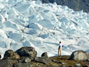 Anders Carlson, a UW–Madison geologist, surveys an outlet glacier in southwest Greenland. Carlson and colleagues from UW–Madison and Oregon State University have shown that melting ice from Greenland may have raised ocean levels less than expected during the most-recent prolonged warm spell on Earth. The surprising patterns of ice melt found by new research suggest that Greenland’s ice sheet may be more stable — and Antarctica’s less stable — than previously thought. Credit: Photo courtesy Robert Hatfield, Oregon State University