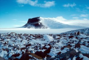 Sirius Group exposures near Mt. Fleming, Antarctica, circa 1986. The pattern of snow behind rocks shows the prevailing winds across the East Antarctic Ice Sheet. Credit: Reed Scherer, Northern Illinois University