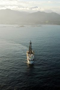 After the March 2011 Mw 9.0 Tohoku-oki Earthquake, the Deep-sea Drilling Vessel (D/V) Chikyu, seen here off-shore Japan, installed a sub-seafloor temperature observatory through the plate boundary fault as part of the Integrated Ocean Drilling Programs' Japan Trench Fast Drilling Project. Fulton and Brodsky present analysis of the observatory data to reveal signals interpreted to be the thermal signature of pulses of water squirting out of fractures in response to aftershocks on neighboring faults. The observation of interactions between faults during the aftermath of a major earthquake helps scientists gain a better understanding of the processes that control earthquake occurrence. See the open-access article, "In situ observations of earthquake-driven fluid pulses within the Japan Trench plate boundary fault zone," by Fulton and Brodsky. Click on the image for a larger version. Photo Credit: JAMSTEC/IODP.