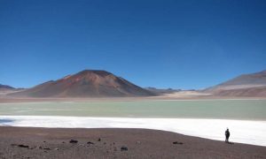 The Altiplano-Puna plateau in the central Andes features vast plains punctuated by spectacular volcanoes, such as the Lazufre volcanic complex in Chile seen here. Credit: Noah Finnegan 