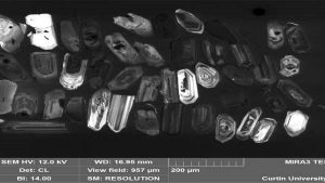 Zircon crystals examined with an electron microscope. The brighter and more concentrically zoned crystals with nice straight edges are the volcanic zircons. Credit: Milo Barham 