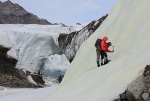 Associate Professor Alexis Templeton and Dr. Stephen Grasby prospecting for sulfur biominerals in a yellow sulfur deposit forming on a glacier surface in the High Arctic. Credit: John Spear