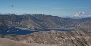 SkyTEM electromagnetic and magnetic survey flying over Spirit Lake, near Mt. St. Helens, Washington. Mt. Adams volcano is in the background.. Credit: Image courtesy of USGS