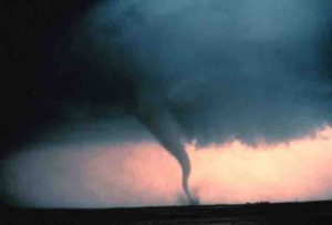 Tornado with dust and debris cloud forming at surface.