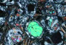 Newly discovered Minerals in Volcanic Rock that May Offer new insights into earth’s evolution fresh olivine (large green, blue and pink crystals) and glass inclusion (lower left inset)