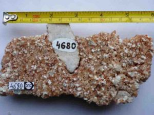 A sample of 2-billion-year-old salt (pink-white recrystallized halite) with embedded fragments of calcium sulfate from a geological drill core in Russian Karelia.