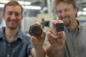 Postdoctoral Fellow Theodore Them (left, holding an extinct fossil sample) and Assistant Professor Jeremy Owens (right, holding a rock core sample). 