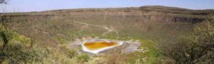 Explosive volcanic crater (maar) with small lake at the bottom close to Dilo