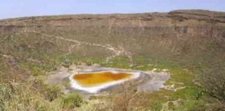 Explosive volcanic crater (maar) with small lake at the bottom close to Dilo