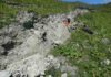Curved slickenlines preserve the direction of rupture propagation A fresh surface rupture of the Kekerengu fault, taken 4 days after the Kaikoura earthquake, with lead author Jesse Kearse leaning next to a curved slickenline (the subject of this article). Photo credit - Professor Tim Little (Victoria University of Wellington).