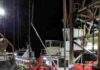 How a drilling ship pulls cores from 2.5 miles below the sea The floormen (in yellow jackets) and drillers (in white booths in background) of Expedition 383 retrieve core barrels and sediment cores around the clock. Credit: Jenny Middleton/Lamont-Doherty Earth Observatory