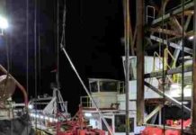 How a drilling ship pulls cores from 2.5 miles below the sea The floormen (in yellow jackets) and drillers (in white booths in background) of Expedition 383 retrieve core barrels and sediment cores around the clock. Credit: Jenny Middleton/Lamont-Doherty Earth Observatory