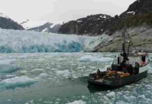 Underwater glacial melting is occurring at higher rates than modeling predicts Researchers on the MV Steller are in front of the terminus of Alaska's LeConte Glacier in August 2016. An over-the-side pole holds the sonar instrument that collects data on the subsurface ice face as the vessel moves slowly through the icy water. Credit: David Sutherland