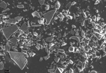 Synchronization of ice cores using volcanic ash layers An electron scanning microscope picture of an ash sample from a 55,500 years old ash layer in the NGRIP ice core. The ash shards are the larger pieces that look like broken glass. The colours are not true. The white bar at the bottom left represents 1/10 mm. Credit: University of Copenhagen