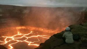 Brittany Erickson, an assistant professor in the Department of Computer and Information Science who studies geophysics and is a colleague of UO’s Leif Karlstrom, peers into the Halema'uma'u lava lake on Hawai’i’s Kiīlauea volcano. Credit: University of Oregon