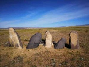 A photo of the stone men (Chimulchek Culture) in the steppe area of Altai Mountains. These figures are characteristic of the peoples who lived in the area around the time of occupation at Tongtian. These specific examples are located at the Chimulchek site (ca. 4000 years old) and not far from Tongtian Cave. Ceramic sherds from the cave suggest that the occupants in the cave shared similar cultural traits to other people in the region. Credit: Jianjun Yu