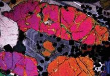 Scientists find evidence of how platinum metals form under 60 million-year-old Scottish volcano Photomicrograph in crossed polars of precious-metal bearing peridotite. Note the optical zoning (light/dark bands) in the plagioclase (grey coloured mineral) in the central part of the image. The occurrence of this zoning was the focus of the study in question. The width of the image frame is 4 mm. Credit: Nat. Geosci. (2020).