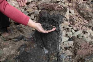 A lump of coal weathering out from Siberian flood basalts in a quarry near the town of Ust Ilimsk Credit: Scott Simper