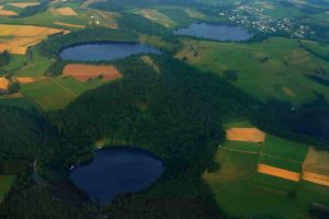 Three water-filled maars in the Eifel, Germany (Gemündener Maar, Weinfelder Maar, Schalkenmehrener Maar). Created by volcanic activity, maars are also found in other parts of Europe and on other continents, but Eifel-Maars are the classic example worldwide.