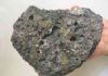 Probing the origin of the mantle’s chemically distinct ‘scars’ Basalt, the most-common rock on Earth’s surface, encases green crystals--a geologic "nesting doll" phenomenon called a xenolith. Basalts such as this one derive from a section of the mantle that has been depleted in incompatible trace elements, which is usually attributed to continental crust formation. In their work, Tucker and his collaborators propose another mechanism that would impart this signature. Credit: Carnegie Institution for Science