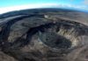 Giant friction experiment at Kilauea volcano A wide-angle aerial view looks southeast over Kīlauea’s summit caldera on July 22, 2021. Large cliffs formed during the 2018 collapses are visible on the left side of the photo. A recently active lava lake is visible in the lower right. (Image credit: M. Patrick, USGS)