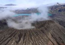 The rim of Cone D—inside the Okmok Volcano caldera—with the blue lake in the background. Credit: Nick Frearson