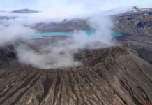 A journey into an Alaskan volcano The rim of Cone D—inside the Okmok Volcano caldera—with the blue lake in the background. Credit: Nick Frearson