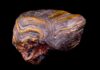 Iron-rich rocks unlock new insights into Earth’s planetary history Metamorphosed banded iron formation from southern Wyoming showing deformation and folding. The rock is approximately 2.7 billion years old. Dark bands are iron oxides (magnetite, hematite) and yellow-orange bands are chert with iron oxide inclusions (jasper). (Photo by Linda Welzenbach-Fries/Rice University)