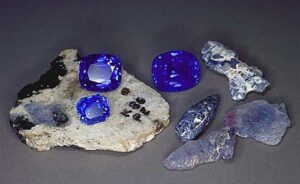A selection of both rough and cut Kashmir sapphires. The cut stones range from 6–14 ct. (Photo: Henry Hänni/SSEF)